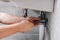 Cropped shot of male plumber in working overall fixing sink by spanner