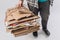 cropped shot of man holding pile of folded cardboard boxes isolated on grey, recycling concept