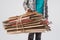 cropped shot of man holding pile of folded cardboard boxes isolated on grey, recycling concept