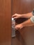 Cropped shot of man inserting card into electronic lock in hotel