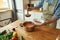 Cropped shot of man pouring tasty soup from pot into bowl. Italian cook preparing traditional meal in the kitchen