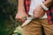 cropped shot of man sharpening log