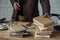 cropped shot of man taking stack of books