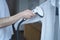 Cropped shot of man using electric garment steamer while steaming while classic shirt at home