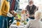 cropped shot of man and woman carrying turkey for thanksgiving dinner while excited family looking