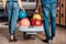 cropped shot of multiethnic couple with bowling balls standing in front of alleys