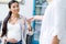 cropped shot of pharmacist giving pills to smiling pregnant woman