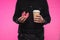 cropped shot of policeman holding bitten doughnut and paper cup