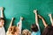 cropped shot of schoolchildren showing thumbs up in front of