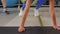 Cropped shot of sporty woman training on yoga mat in gym