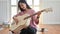 Cropped shot of a Teenage girl playing a guitar while staying at home while quarantine the Covid-19 virus