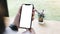 Cropped shot top view of woman hands using smartphone mockup at the white office desk. Blank screen mobile phone for graphic