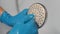 Cropped shot of unrecognizable housewife wearing protective gloves cleaning calcified shower head using brush ruff in