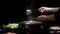 Cropped shot of woman eating Shabu-Shabu in hot pot with fresh sliced meat dipping in cheese with black background