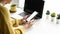 Cropped shot of woman hands holding smart phone at her workspace. Blank screen for your text message.