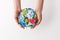 cropped shot of woman holding handmade globe with read heart in hands