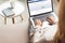 cropped shot of woman at home sitting on couch and using laptop with facebook