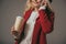 cropped shot of woman with paper cup of coffee talking by phone