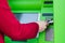 cropped shot of woman putting credit card into atm