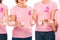 cropped shot of women in pink t-shirts with breast cancer awareness ribbons holding cubes with word cancer