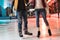 cropped shot of young couple in skates holding hands and ice skating