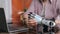 Cropped shot of young disabled man sit at desk, remove arm prosthesis and leave