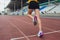 Cropped shot of young female athlete launching off the start line in a race. Female runner started the sprint from the