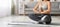 Cropped Shot Of Young Female In Sportswear Meditating In Home Interior