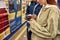 Cropped shot of young people using smartphones while standing at the subway metro station. Couple of teenagers using