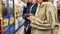 Cropped shot of young people using smartphones at the subway metro station. Couple of teenagers using mobile app