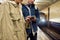 Cropped shot of young people using smartphones while waiting for the train at the subway metro station. Couple of