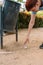 cropped shot of a young urban girl, picking up litter from the ground to put it in a litter bin. young environmentalist