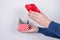 Cropped side profile photo of student`s hands showing holding unwrapped red small little package full of money isolated grey