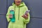 cropped sportswoman in hoodie holding bottle