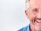 Cropped Studio Shot Of Mature Man Against White Background Laughing At Camera