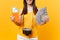 Cropped tourist woman in summer casual clothes holding bundle of dollars money, passport isolated on yellow orange