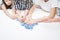 Cropped unrecognizable children hands hold blue playing cards on white table. Smart game for time, who first. Family fun