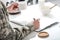 cropped view of army soldier sitting at kitchen table, writing and