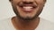 Cropped view of a bearded young man smiling to camera. Studio footage of excited guy expressing positive emotions on