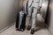 Cropped view of businessman in grey suit with suitcase walking