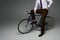 Cropped view of businessman sitting on bicycle