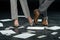 cropped view of businesspeople standing on floor with documents and dollar banknotes,