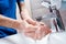 Cropped view of doctor washing soapy hands