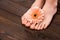 cropped view of feet with natural pedicure and gerbera flower