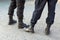 Cropped view image of the legs of municipal police men on the street patrol in high army  black boots and uniform