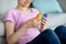 Cropped view of Indian teenage girl playing with antistress POP IT toy at home, closeup of hands