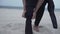 Cropped View Of A Man Wearing Wetsuit On Sandy Beach Of Mallorca Island In Spain. Closeup