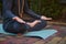 Cropped view of a man yogi in gray sportswear, sitting palms up, practicing yoga. Prayer, gratitude. Yoga hand pose.