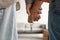 Cropped view of millennial couple holding hands and key to new home, moving in together. Mortgage for young families