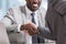 cropped view of multiethnic businessmen in suits